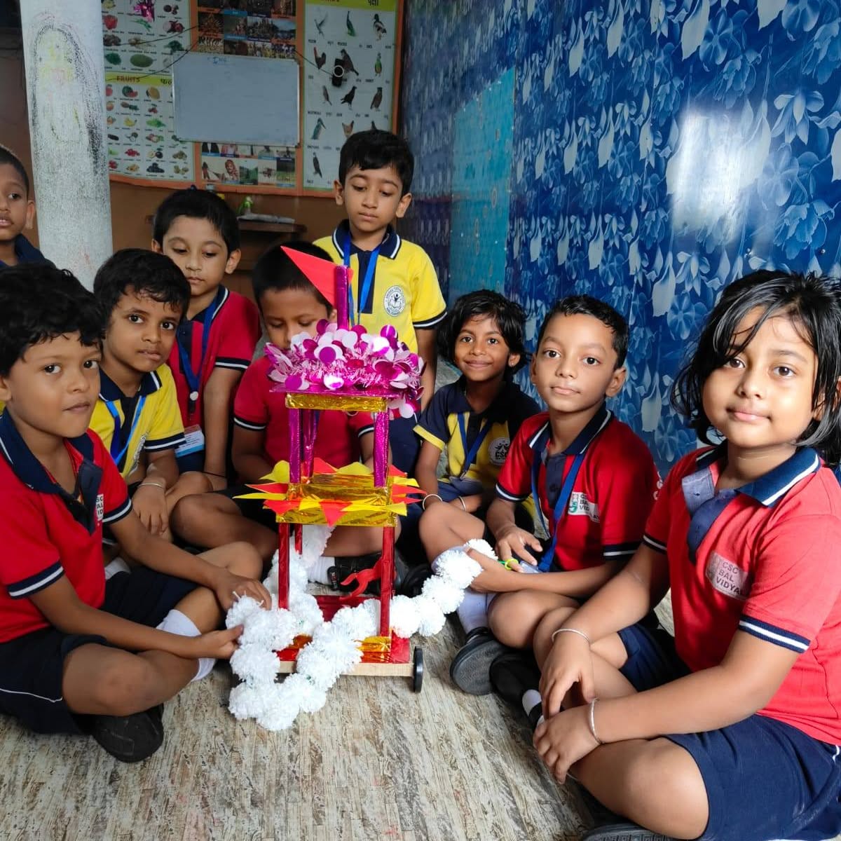 Children doing craft activity with their teacher