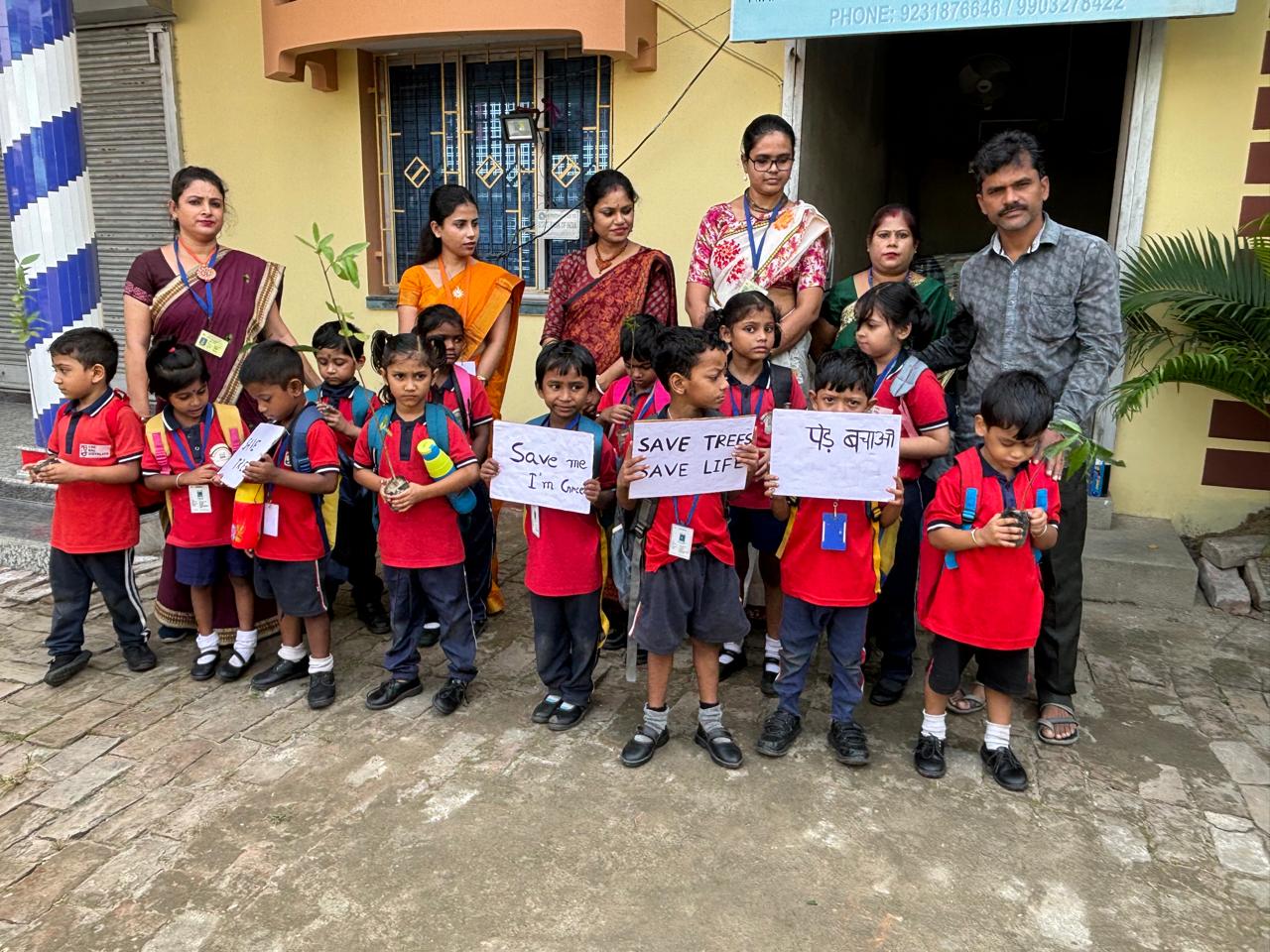 Students holding a banner along with their teachers
