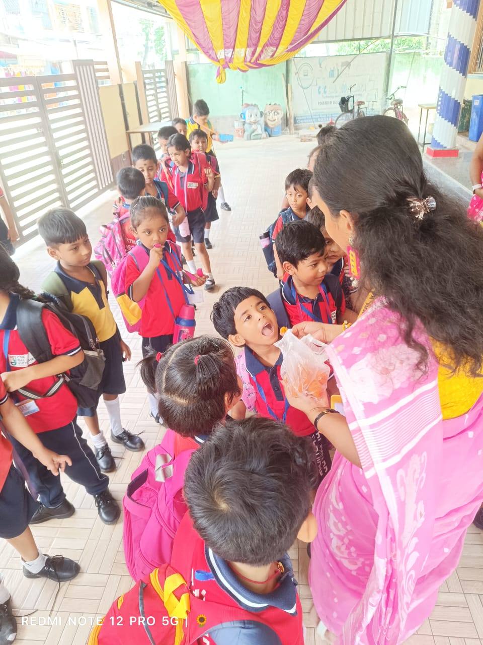 Children lined up with their teacher at Shishu Tirtha School