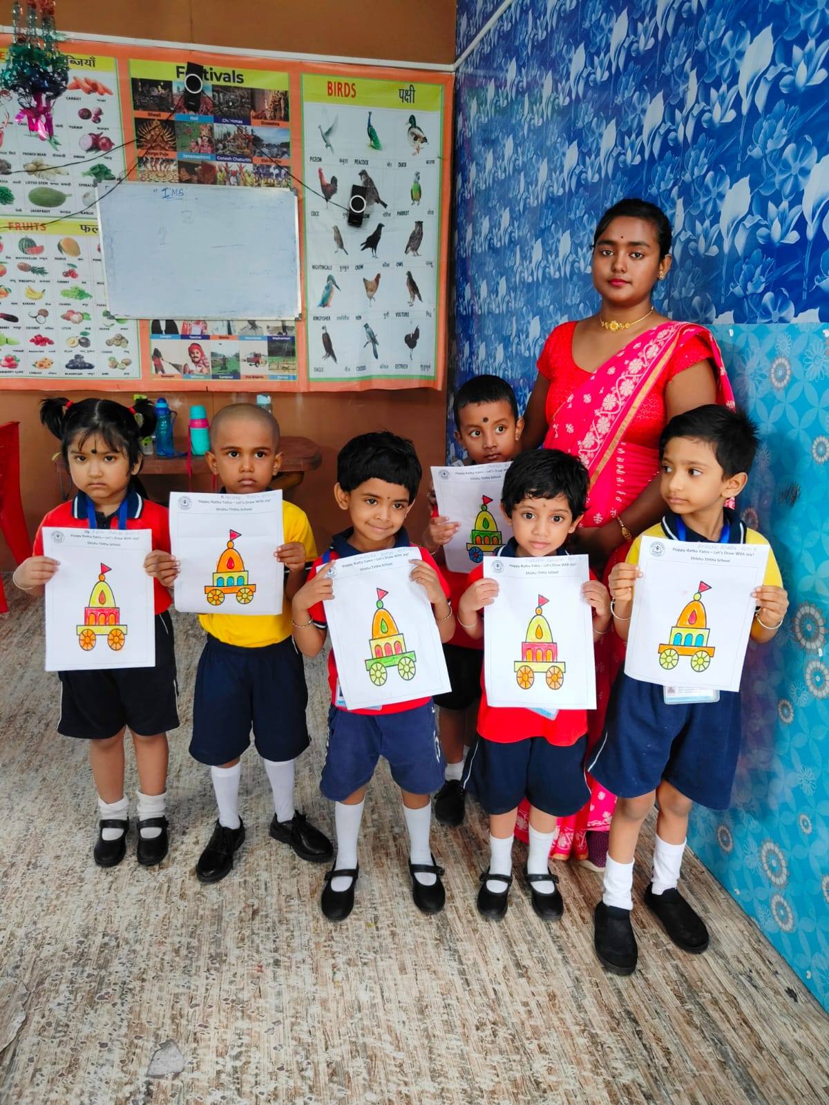 Children posing with their artwork at Shishu Tirtha School