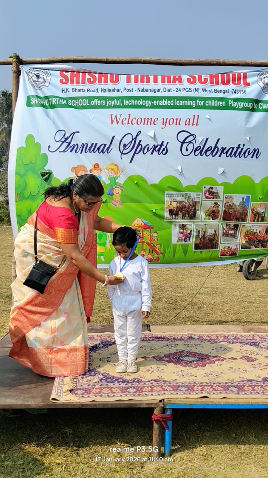 Founder giving a medal to a student