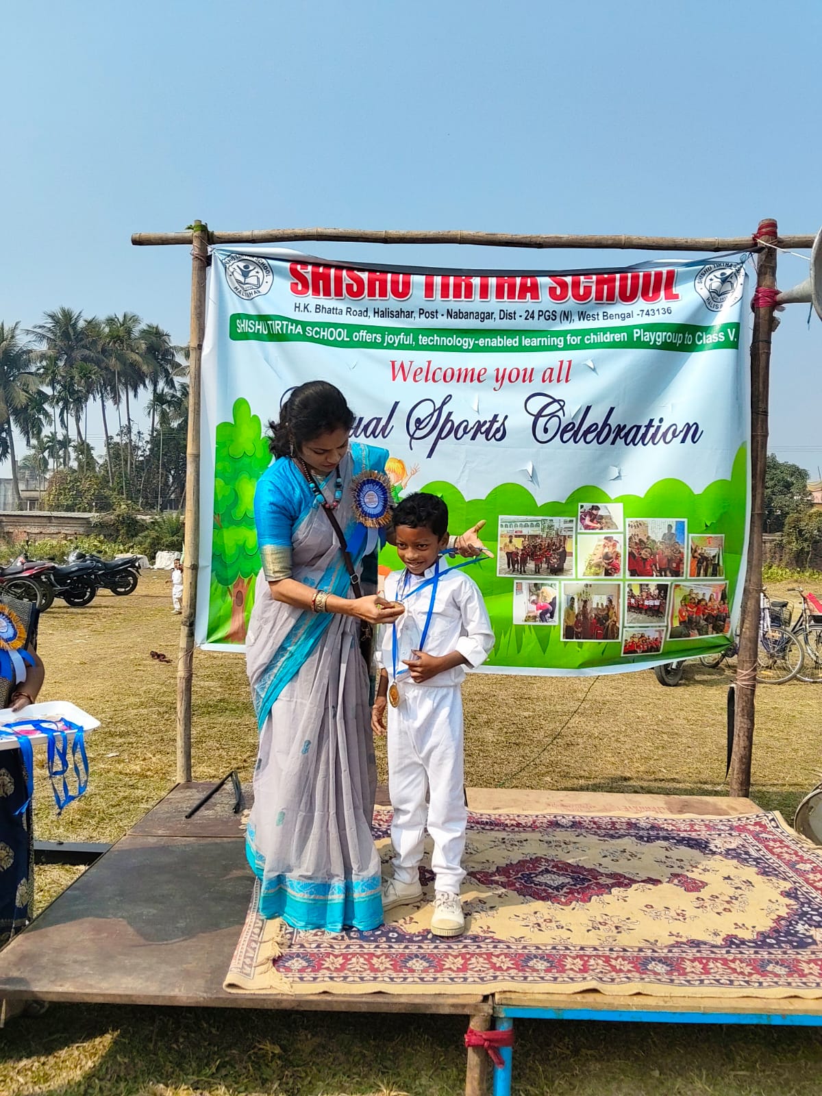 Principal giving a medal to a student on Annual Sports Day